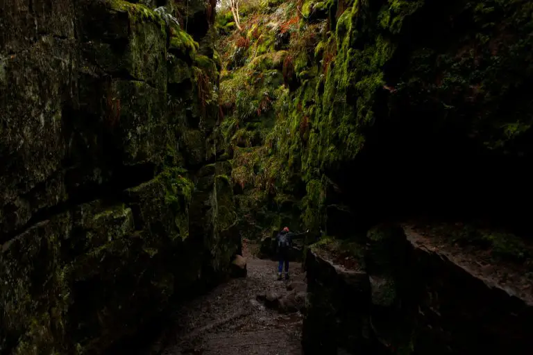 Woman walking through the bottom of Lud's Church.